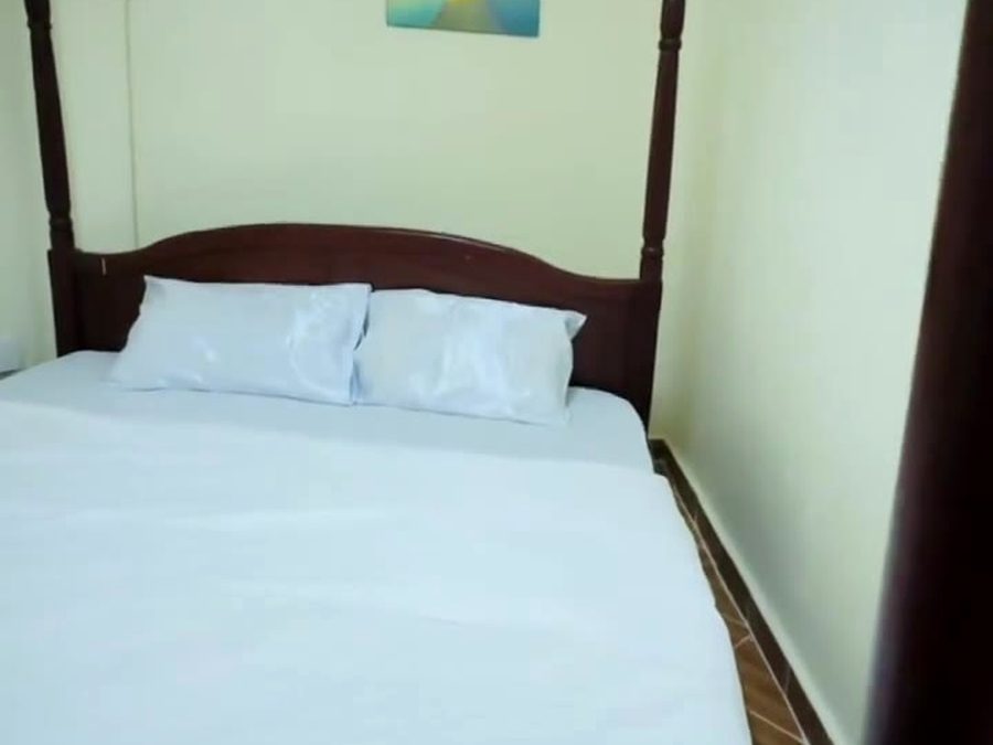 Fresh white linen and pillows on a bed at Emory Resort